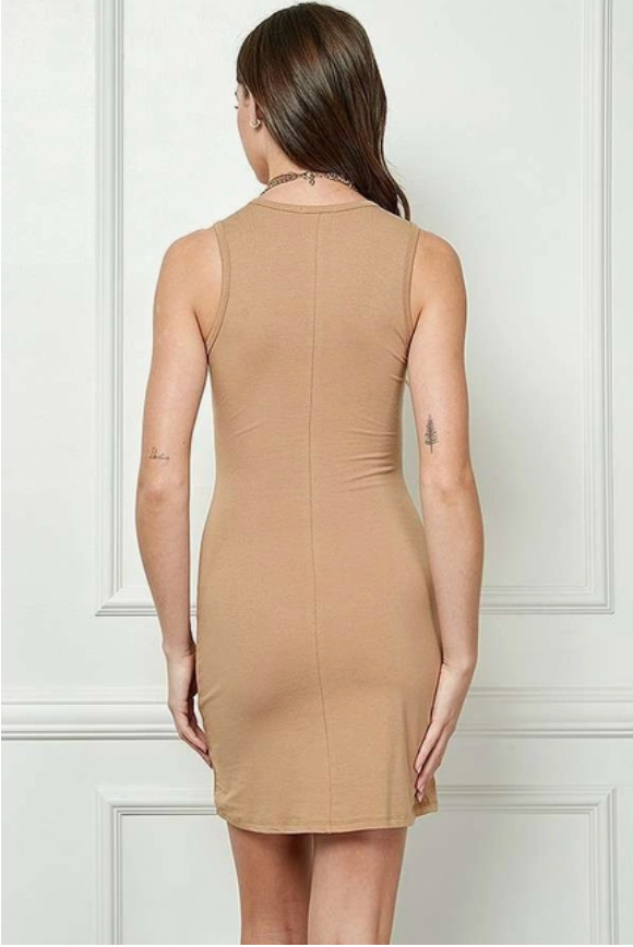back view of model with long brown hair wearing camel-colored body con mini dress